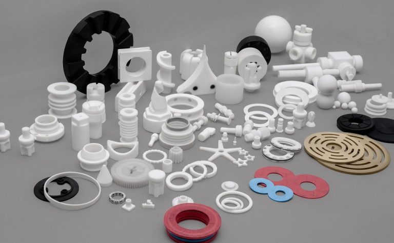 Assorted CNC machined plastic parts in various shapes and colors