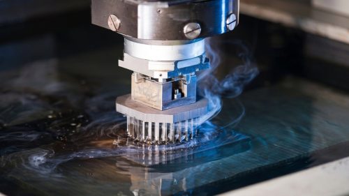 Sinker EDM electrode machining a metal die with sparks