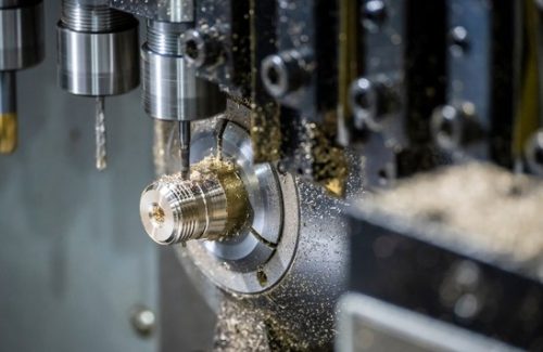 Swiss-type lathe turning a small brass part