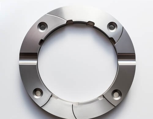Titanium flange with bolt holes and machined features