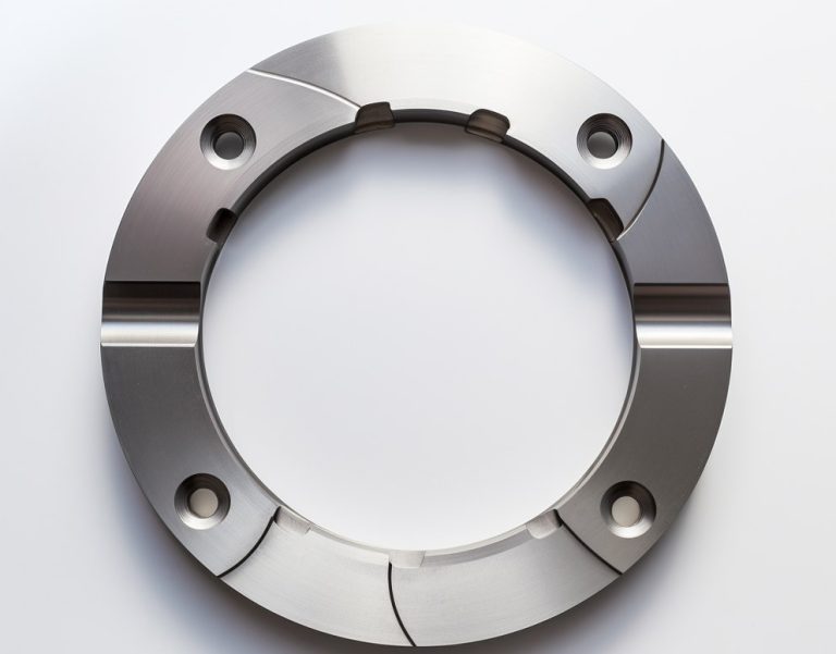 Circular titanium flange with bolt holes and slots