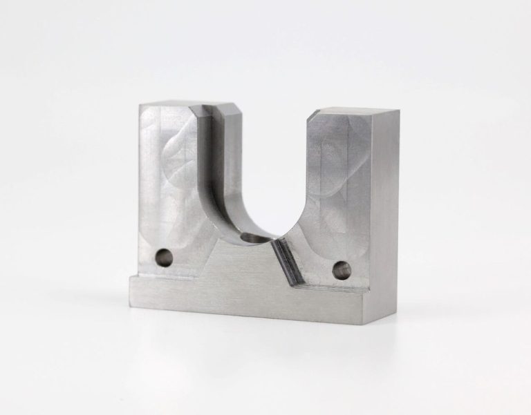 Machined u-shaped metal bracket on white background