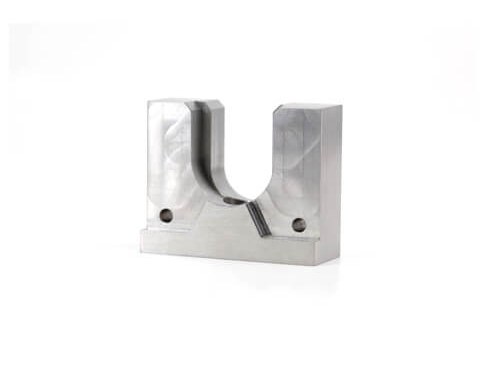 Machined tool steel part with U-shaped groove and holes