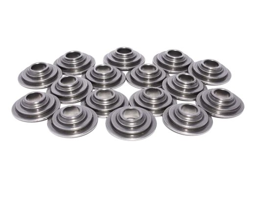 Multiple machined metal bushings on white background