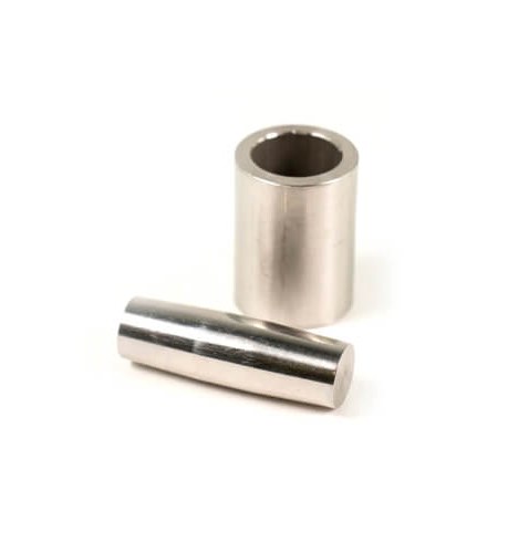 Two cylindrical machined metal bushings on white