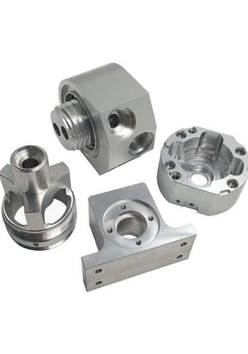 Four machined mild steel components with threaded holes and smooth finishes