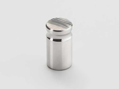 Cylindrical metal part with machined top surface
