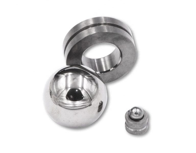 Three precision machined metal parts on white