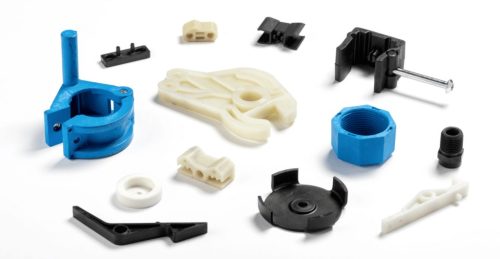 Assortment of plastic molded parts on white background
