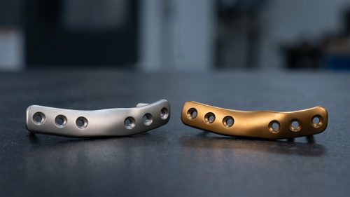 Titanium parts comparing natural gray color and anodized finish
